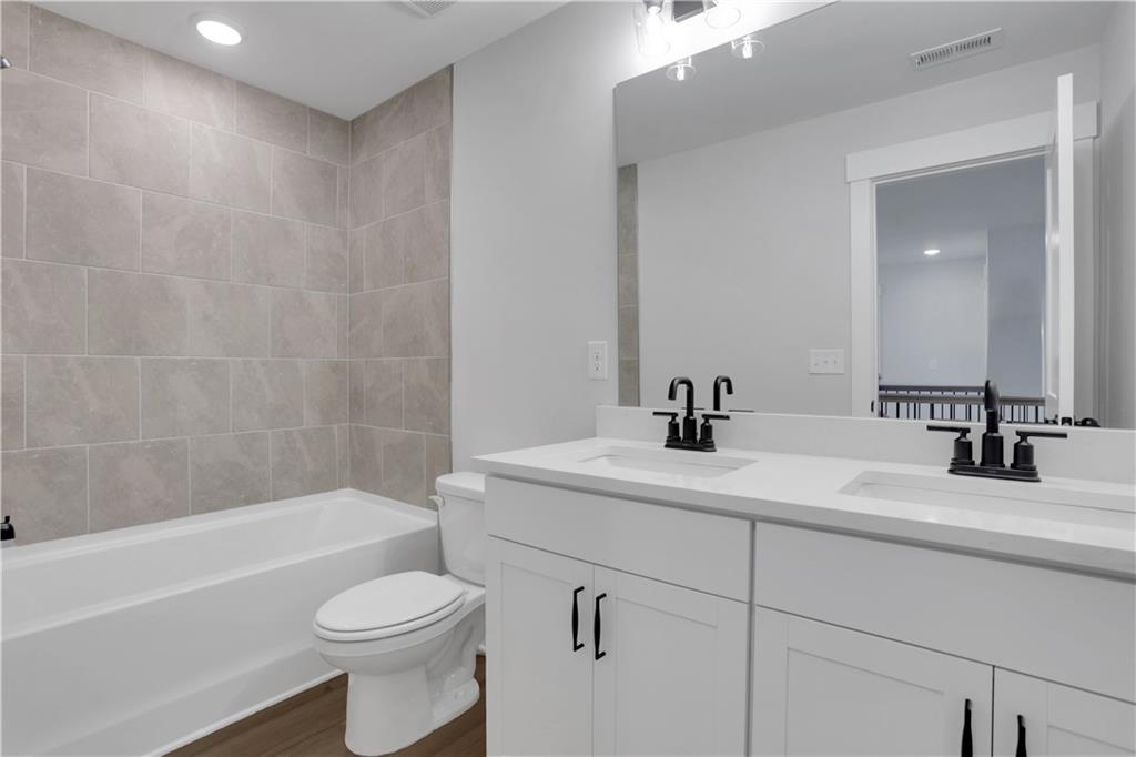 508 Pine Bough Road Ball Ground, GA 30107 - Photo 44 of 47 a bathroom with a sink a toilet and a bathtub