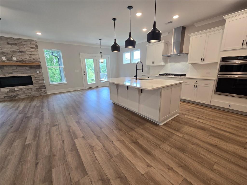508 Pine Bough Road Ball Ground, GA 30107 - Photo 8 of 47 a large kitchen with cabinets wooden floor and stainless steel appliances
