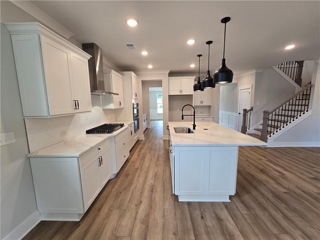 508 Pine Bough Road Ball Ground, GA 30107 - Photo 10 of 47 a large kitchen with stainless steel appliances kitchen island a large counter top a sink a stove and a refrigerator