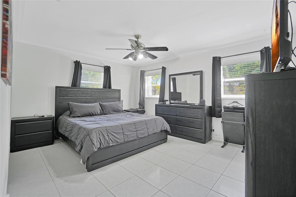 8101 Southwest 198th Street Cutler Bay, FL 33189 - Photo 13 of 16 a bedroom with a bed and a chandelier