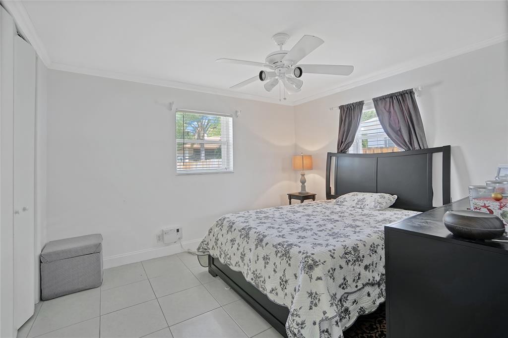 8101 Southwest 198th Street Cutler Bay, FL 33189 - Photo 14 of 16 a bedroom with a bed and a chandelier
