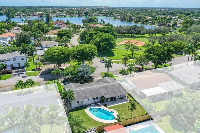 an aerial view of a house with yard swimming pool and outdoor seating