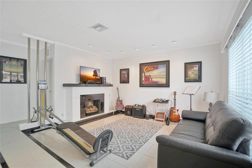 8101 Southwest 198th Street Cutler Bay, FL 33189 - Photo 4 of 16 a living room with furniture and a fireplace