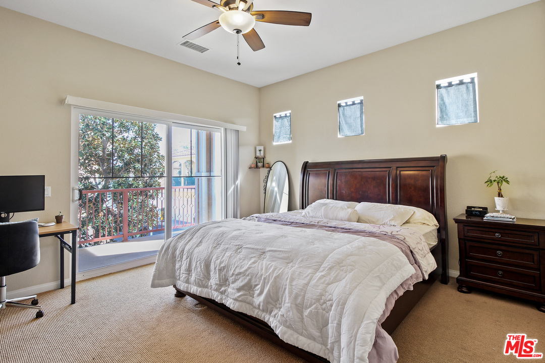 4153 Paredo Way, Unit A Simi Valley, CA 93063 - Photo 17 of 33 a bedroom with a bed and a chandelier