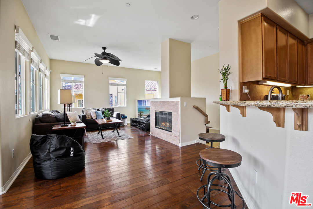 4153 Paredo Way, Unit A Simi Valley, CA 93063 - Photo 5 of 33 a living room with furniture a fireplace and wooden floor