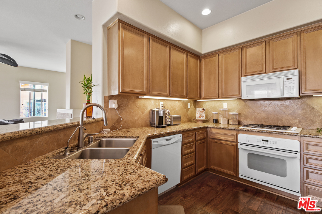 4153 Paredo Way, Unit A Simi Valley, CA 93063 - Photo 9 of 33 a kitchen with a sink stove and cabinets