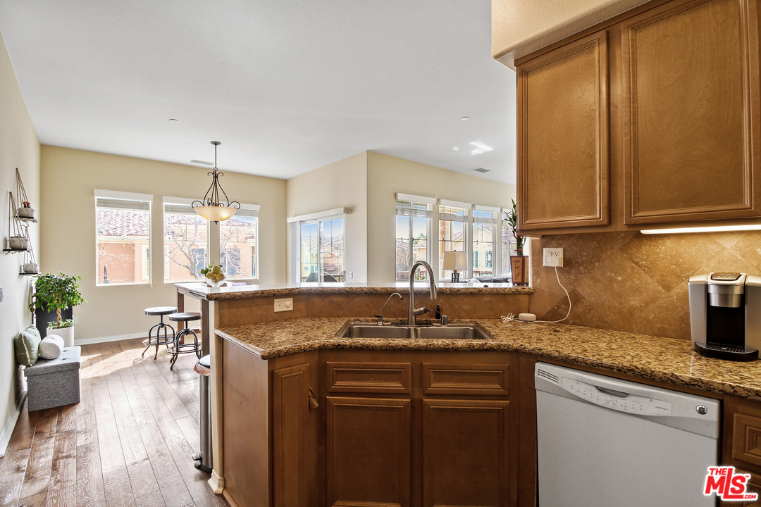 4153 Paredo Way, Unit A Simi Valley, CA 93063 - Photo 10 of 33 a kitchen with granite countertop a sink a counter top space and living room