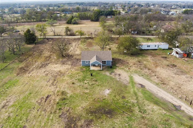 an aerial view of a house with a lake view