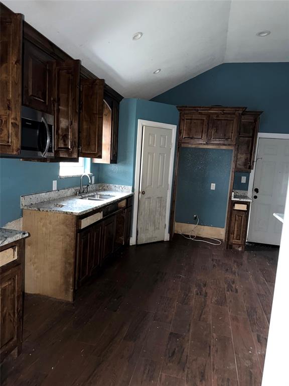 7501 Fm 3383 Road Corsicana, TX 75110 - Photo 3 of 16 Kitchen featuring dark brown cabinetry, dark wood-style floors, lofted ceiling, and stainless steel microwave