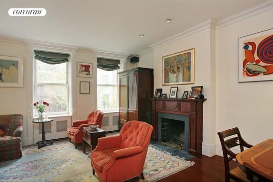 116 East 91st Street Manhattan, NY 10128 - Photo 7 of 11 a living room with furniture a window and a fireplace