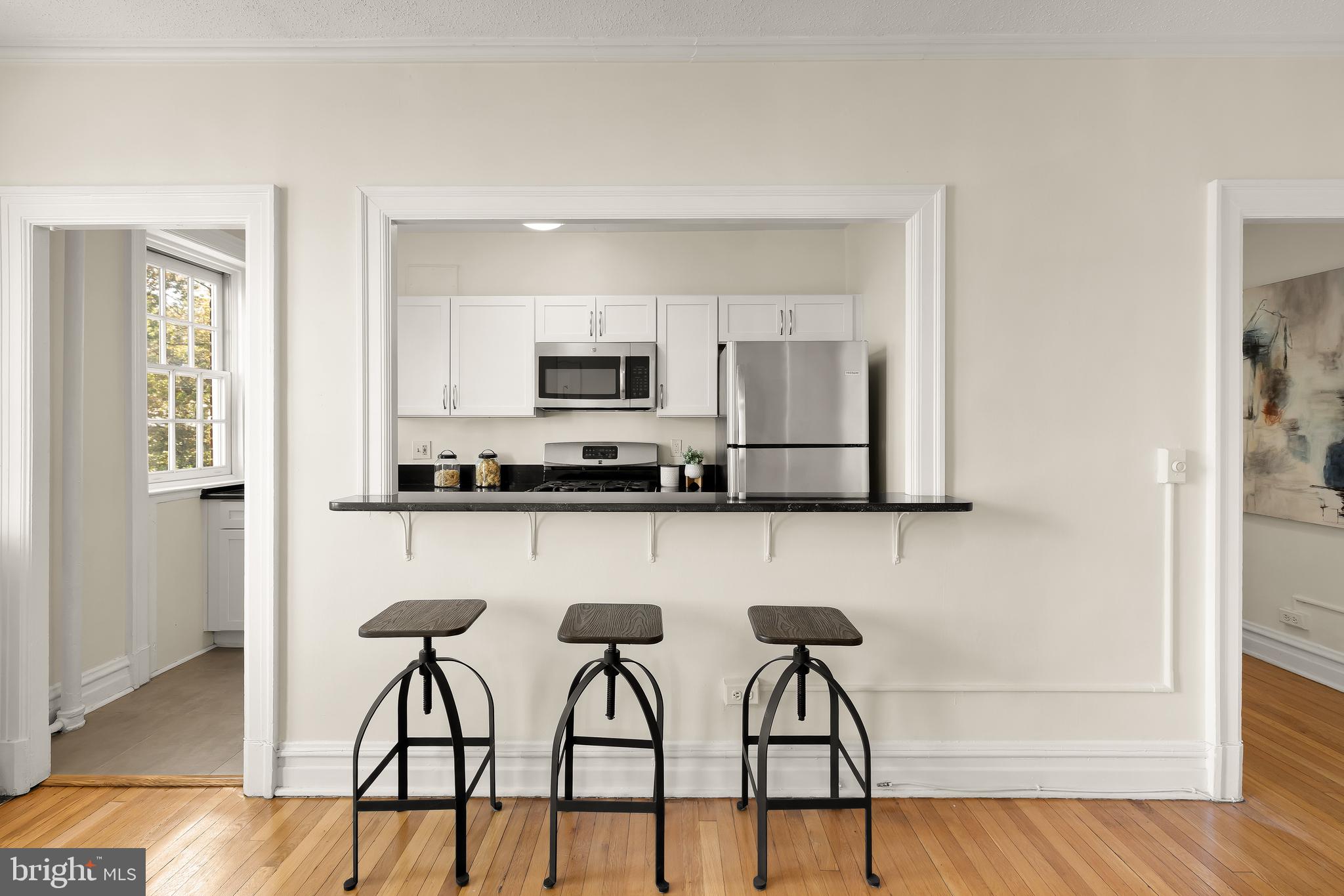 2456 20th Street Northwest, Unit 403 Washington, DC 20009 - Photo 7 of 16 a kitchen with stainless steel appliances a stove a sink cabinets and a refrigerator