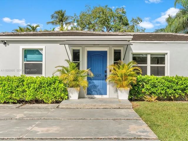 front view of a house with potted plants