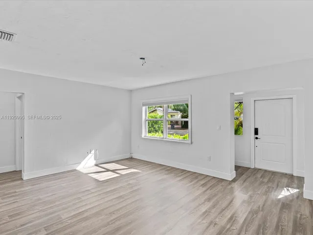 a view of room with wooden floor and window