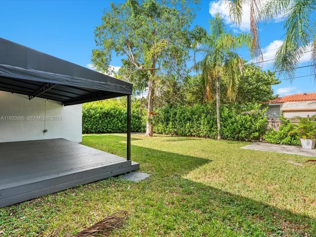 a view of a backyard with a garden and plants