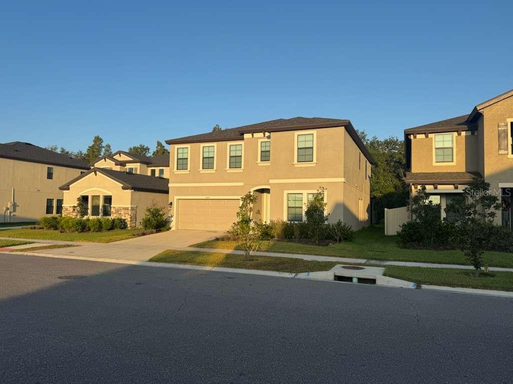 a front view of a house with a yard and garage