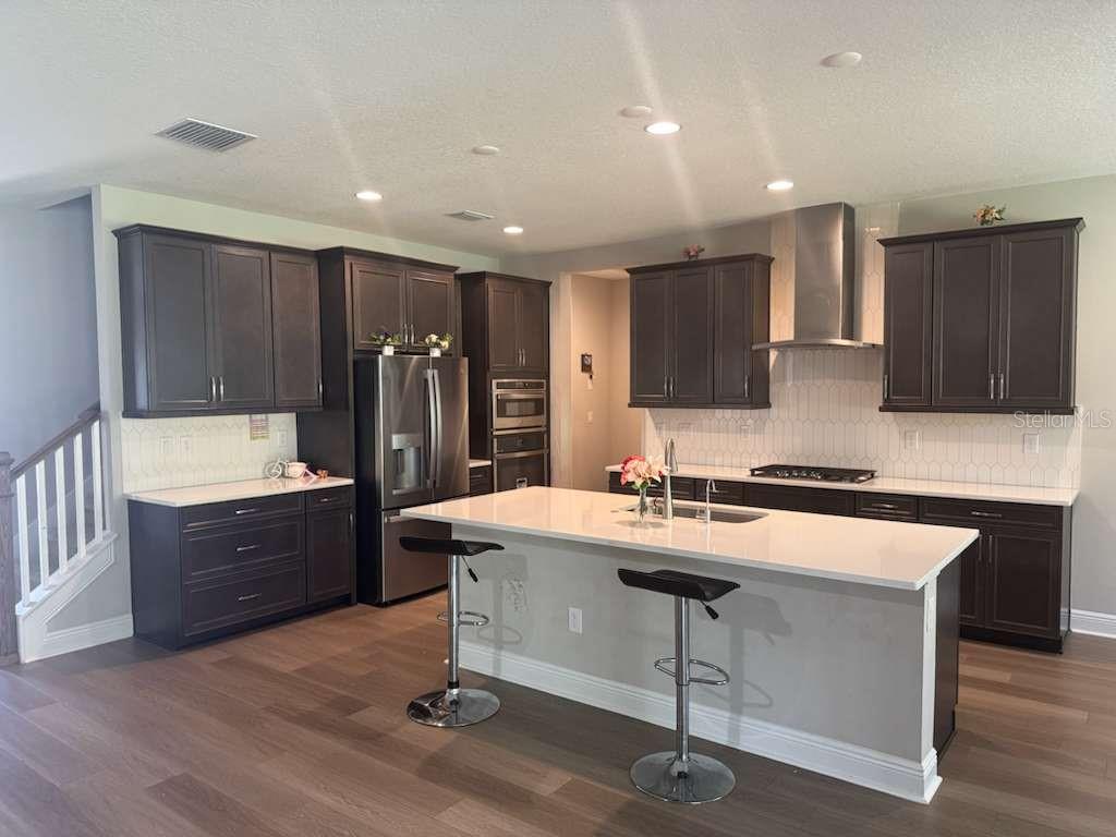 14698 Horse Trot Road Lithia, FL 33547 - Photo 2 of 5 a kitchen with a sink a stove a refrigerator and cabinets
