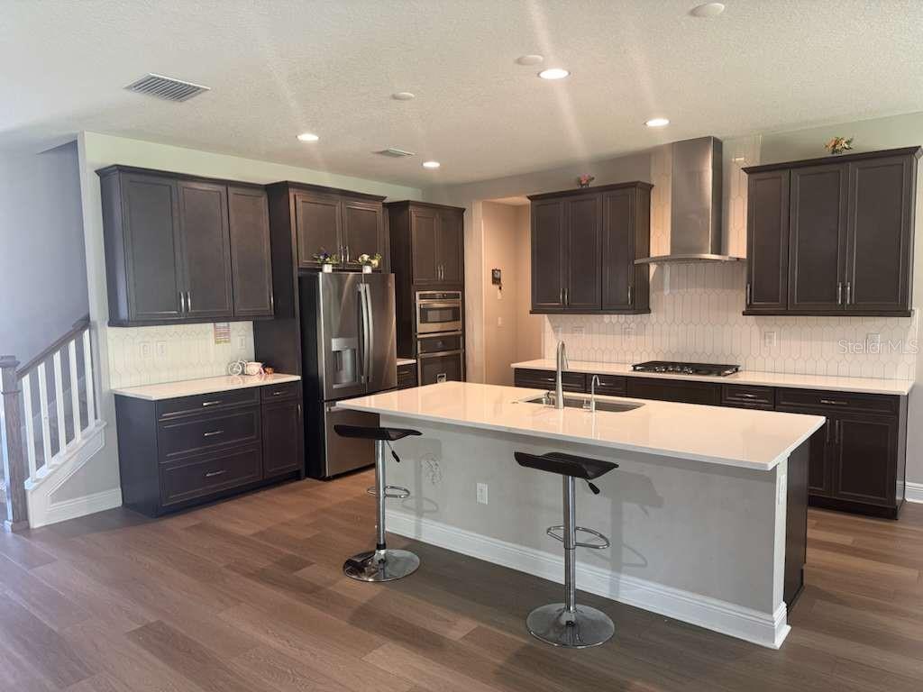 14698 Horse Trot Road Lithia, FL 33547 - Photo 5 of 5 a large kitchen with a center island wooden floor and stainless steel appliances