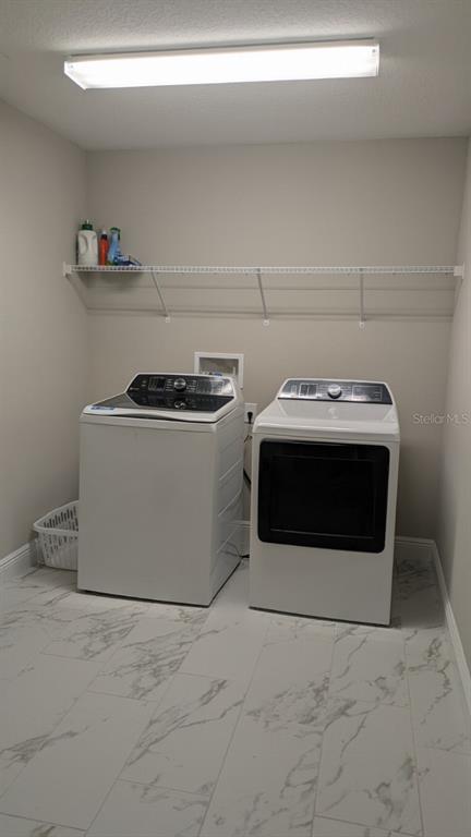 14698 Horse Trot Road Lithia, FL 33547 - Photo 9 of 13 a utility room with washer and dryer