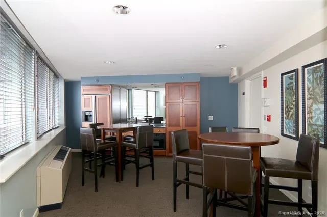 a view of a dining room with furniture and window