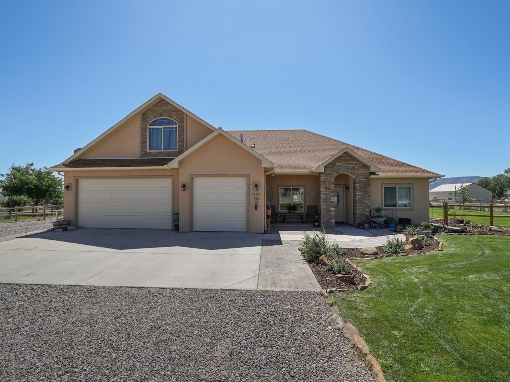 1855 Golden Ranch Road Fruita, CO 81521 - Photo 1 of 24 a front view of a house with a yard and garage