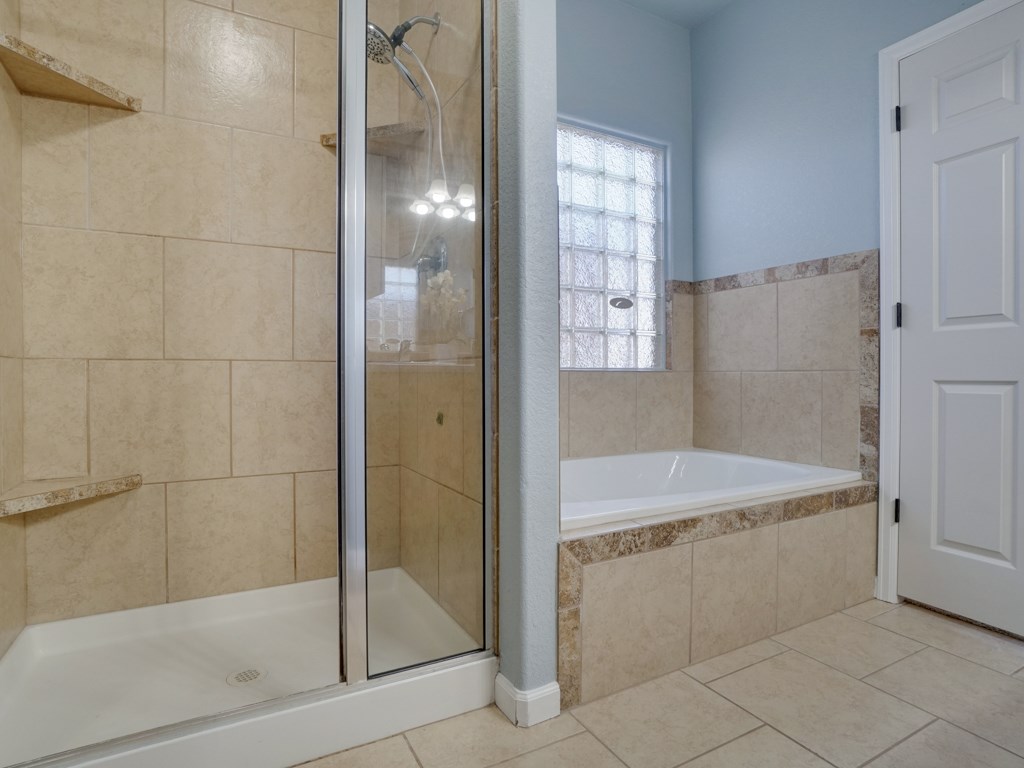 1855 Golden Ranch Road Fruita, CO 81521 - Photo 12 of 24 a bathroom with a bathtub and a shower