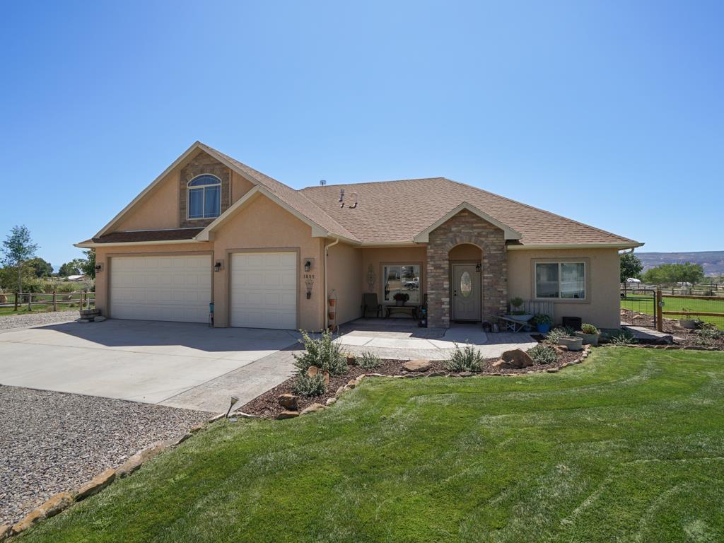 1855 Golden Ranch Road Fruita, CO 81521 - Photo 17 of 24 a view of a house with a yard and sitting area