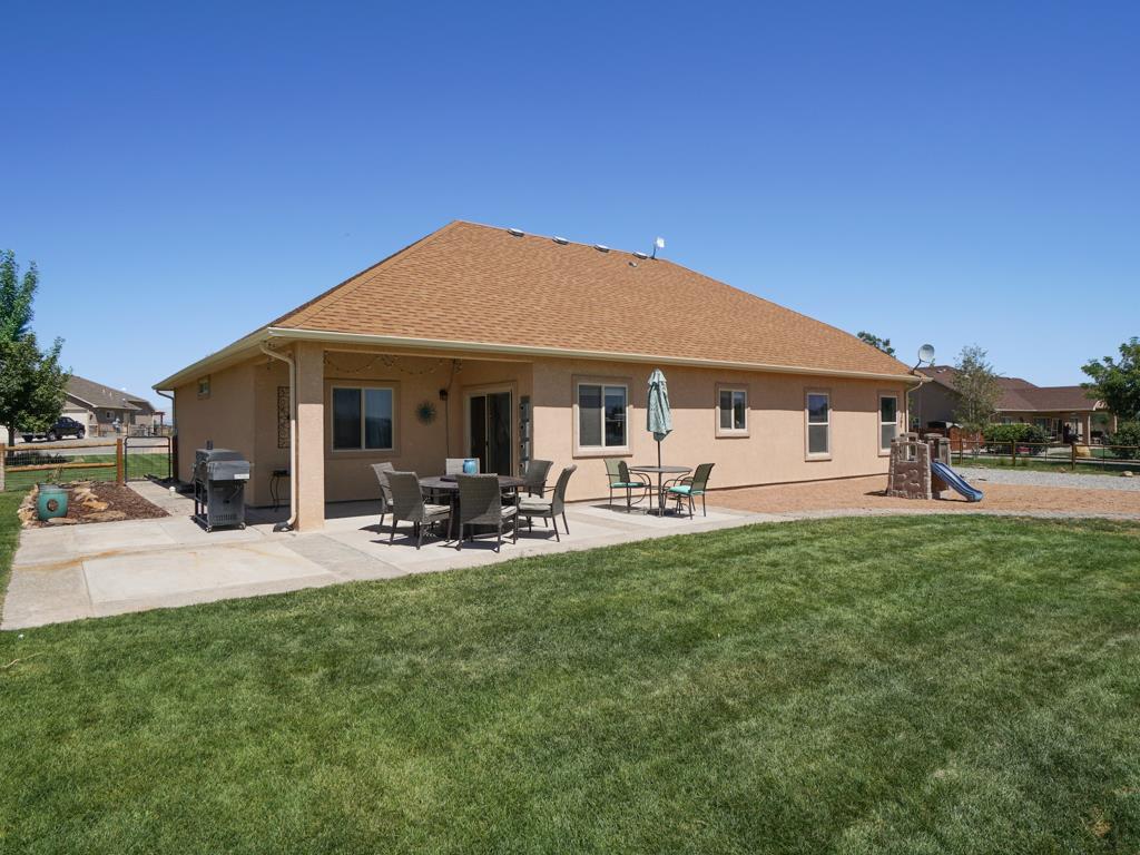 1855 Golden Ranch Road Fruita, CO 81521 - Photo 18 of 24 a view of a house with backyard porch and sitting area