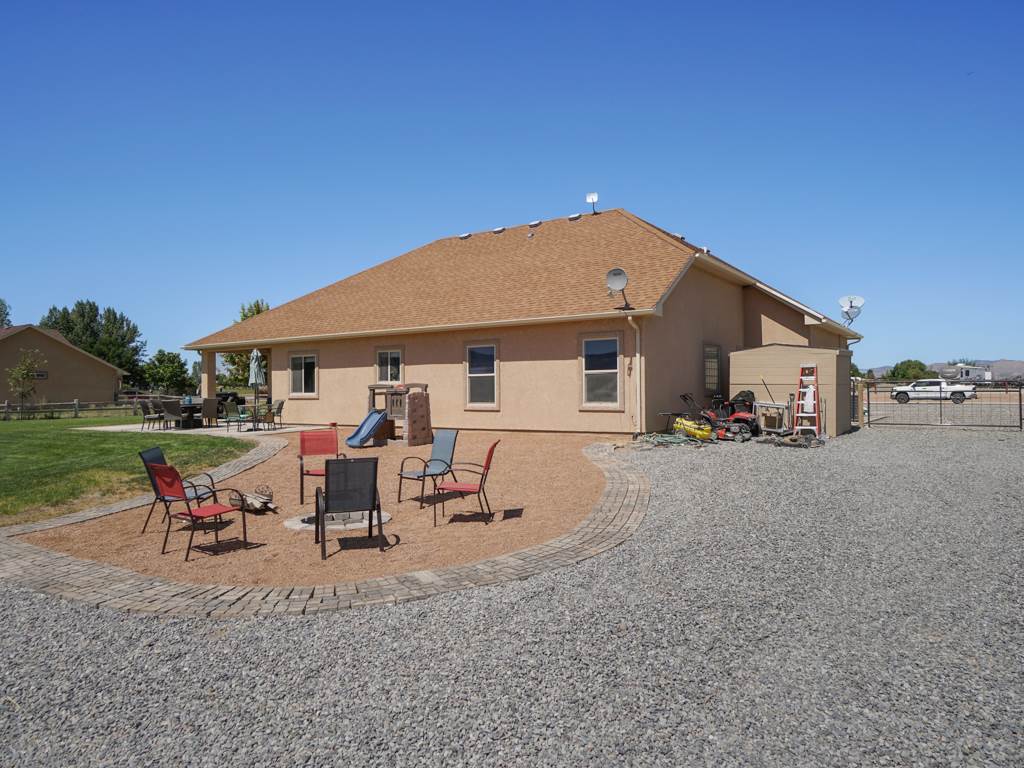 1855 Golden Ranch Road Fruita, CO 81521 - Photo 19 of 24 a view of a house with backyard porch and outdoor seating