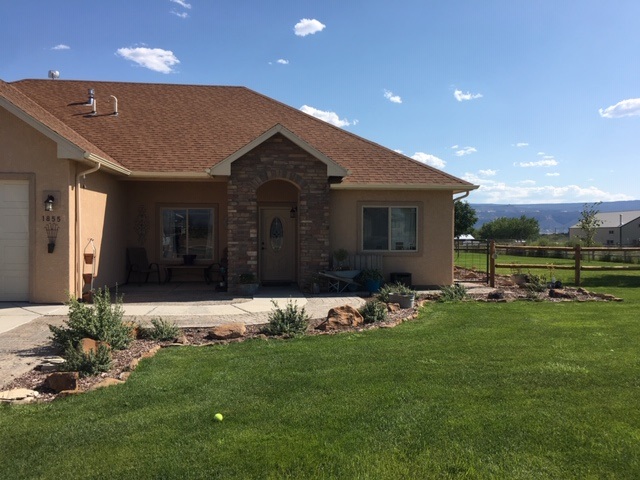1855 Golden Ranch Road Fruita, CO 81521 - Photo 2 of 24 a front view of a house with garden