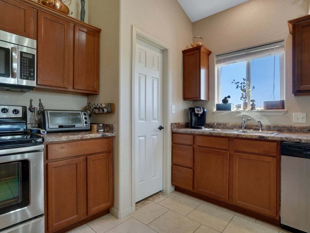 1855 Golden Ranch Road Fruita, CO 81521 - Photo 24 of 24 a kitchen with stainless steel appliances granite countertop a sink stove and microwave