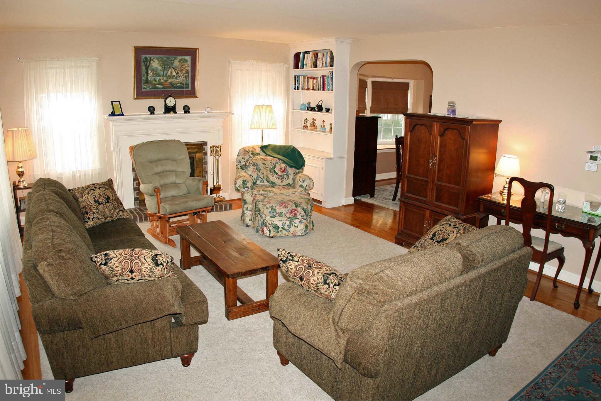 1835 Glen Ridge Road Baltimore, MD 21286 - Photo 5 of 30 a living room with furniture a fireplace and a flat screen tv