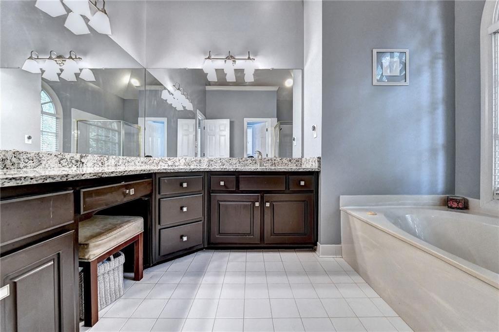1595 Chadberry Way Lawrenceville, GA 30043 - Photo 12 of 47 a bathroom with a granite countertop double vanity sink and a mirror