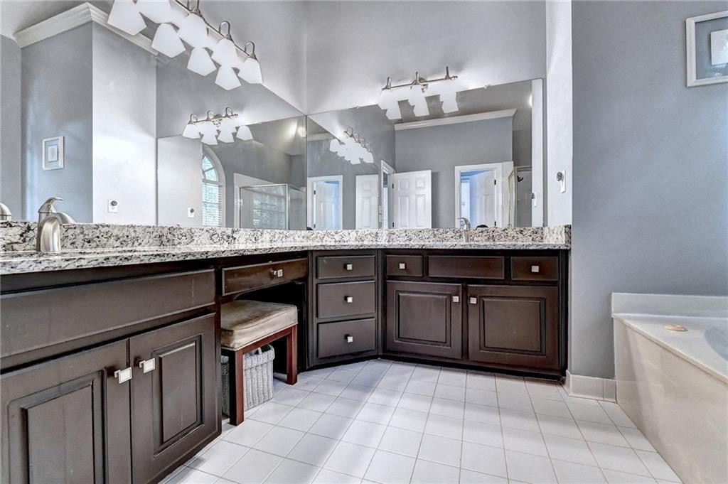 1595 Chadberry Way Lawrenceville, GA 30043 - Photo 13 of 47 a spacious bathroom with a granite countertop double vanity sink mirror and