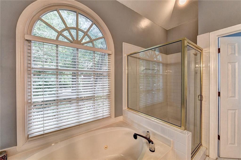 1595 Chadberry Way Lawrenceville, GA 30043 - Photo 14 of 47 a bathroom with a bathtub and a shower