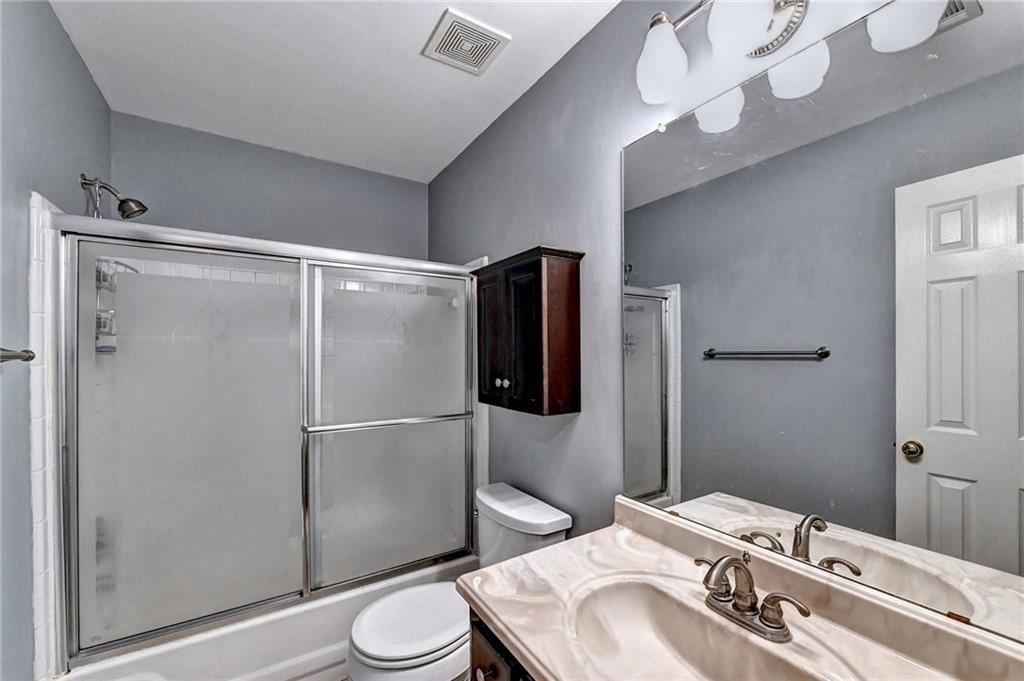 1595 Chadberry Way Lawrenceville, GA 30043 - Photo 16 of 47 a bathroom with a sink toilet and shower