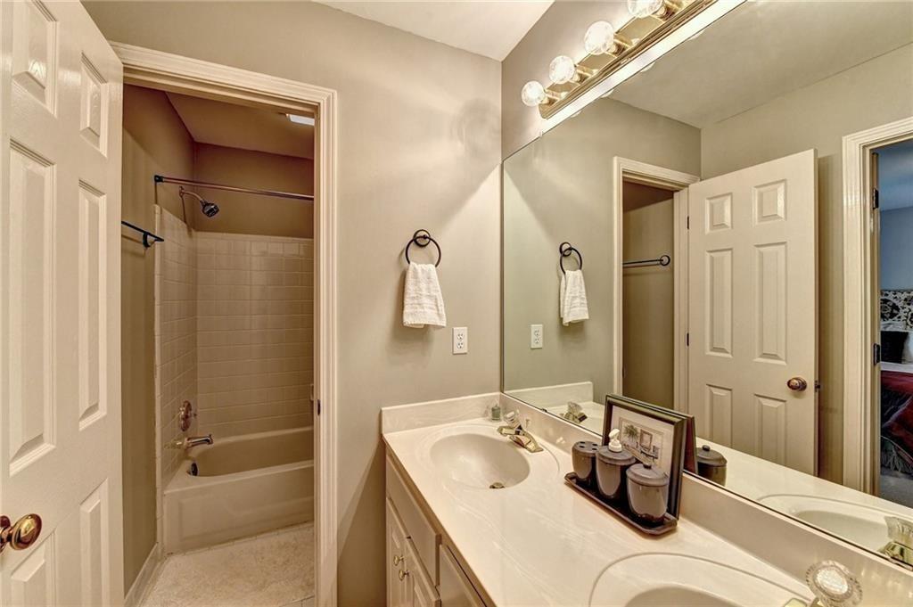 1595 Chadberry Way Lawrenceville, GA 30043 - Photo 17 of 47 a bathroom with a tub sink and mirror