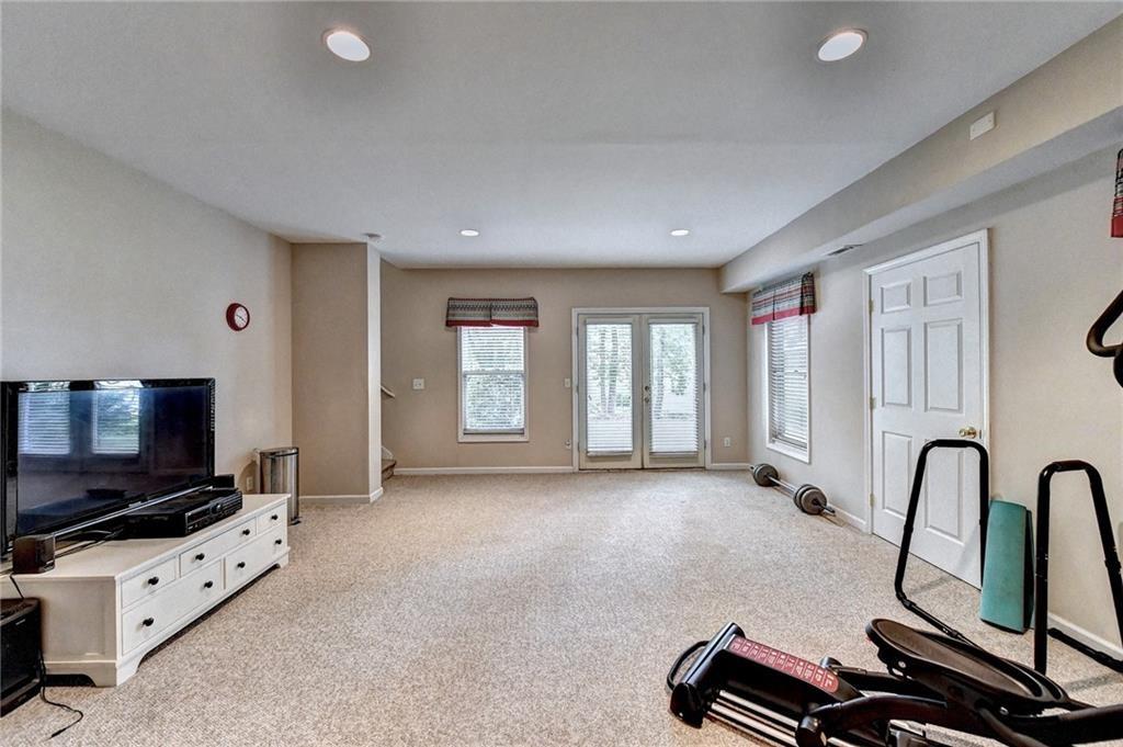 1595 Chadberry Way Lawrenceville, GA 30043 - Photo 18 of 47 a room with furniture and flat screen tv