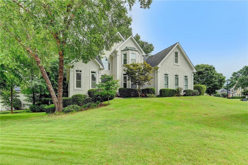 1595 Chadberry Way Lawrenceville, GA 30043 - Photo 2 of 47 a view of a house with a big yard potted plants and large tree