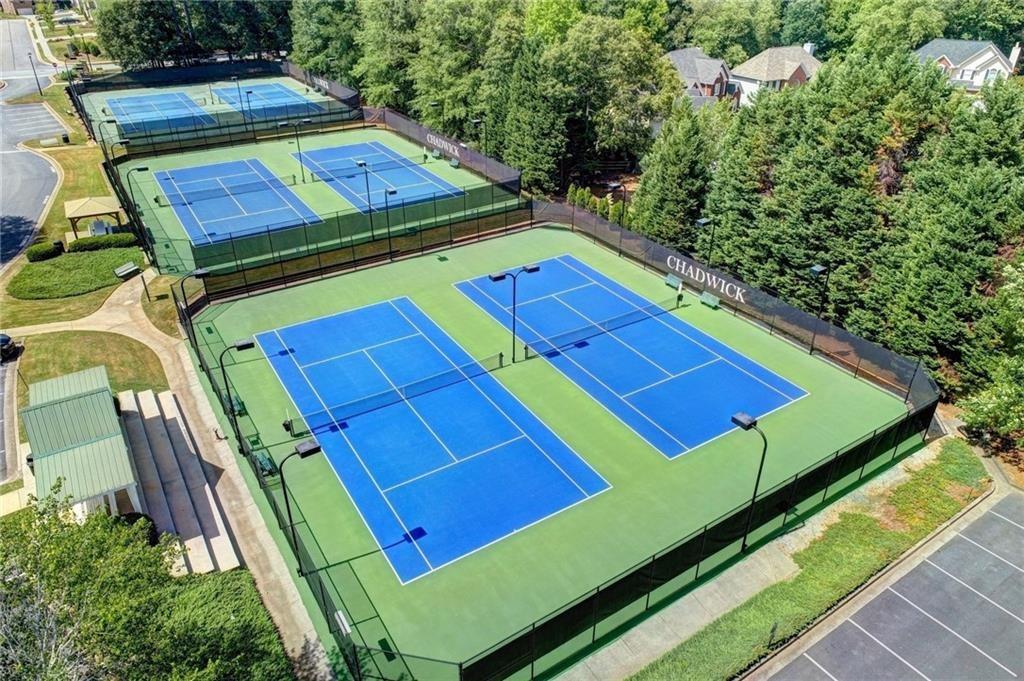 1595 Chadberry Way Lawrenceville, GA 30043 - Photo 25 of 47 a view of a tennis ground with large trees