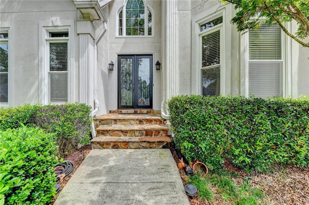 1595 Chadberry Way Lawrenceville, GA 30043 - Photo 3 of 47 a front view of a house with a garden