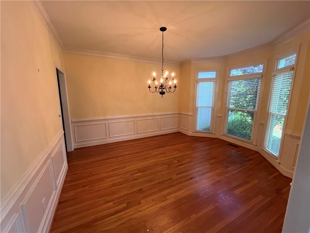 1595 Chadberry Way Lawrenceville, GA 30043 - Photo 33 of 47 a view of an empty room with wooden floor and a window