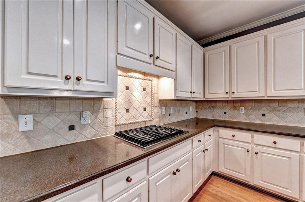 1595 Chadberry Way Lawrenceville, GA 30043 - Photo 7 of 47 a kitchen with granite countertop white cabinets and white appliances