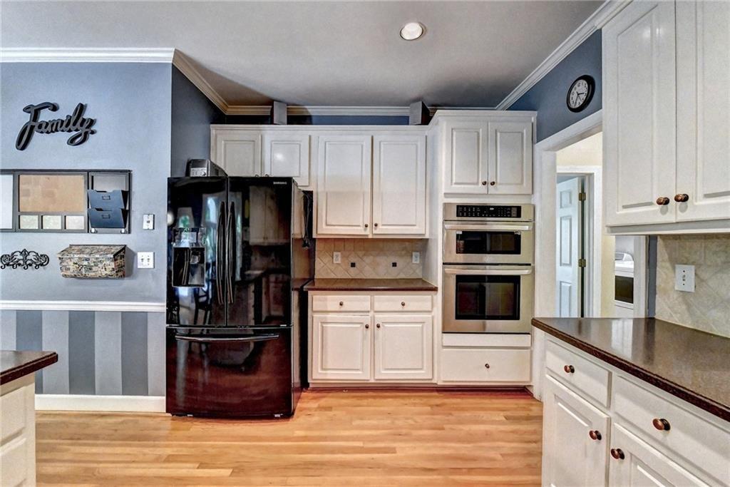 1595 Chadberry Way Lawrenceville, GA 30043 - Photo 9 of 47 a kitchen with kitchen island cabinets and stainless steel appliances