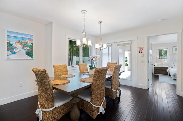 a view of a porch with chairs and potted plants