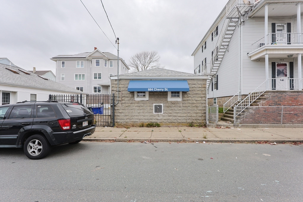 a view of a car parked in front of a house