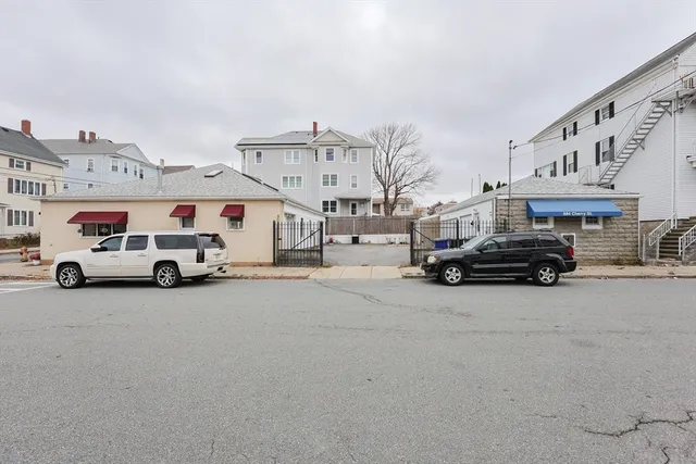 a view of a cars park in front of a building