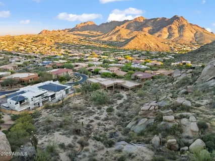 a view of a building with mountains in the background