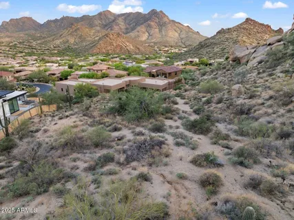 a view of a dry yard with mountains in the background