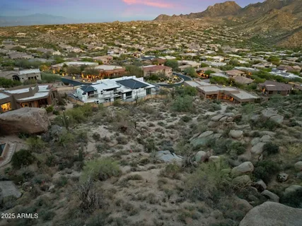 an aerial view of houses covered in trees