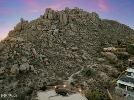 an aerial view of residential houses with outdoor space and trees
